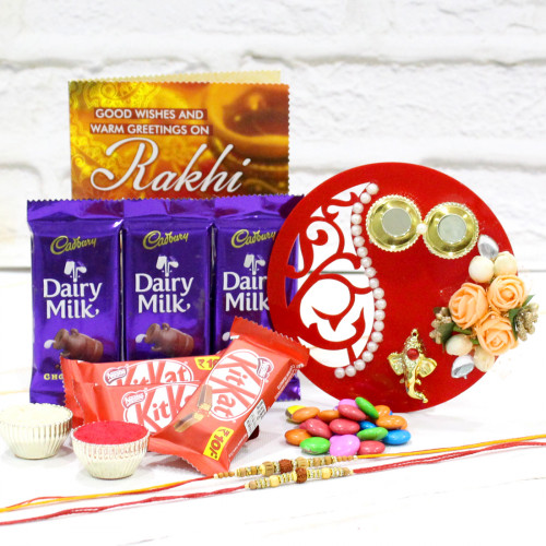 Chocolate Thali Combo - 3 Dairy Milk, 3 Kit Kat, 2 Gems, Fancy Ganesha Thali with Flowers &  Pearls, 2 Rakhi, Free Greeting Card & Roli-Chawal