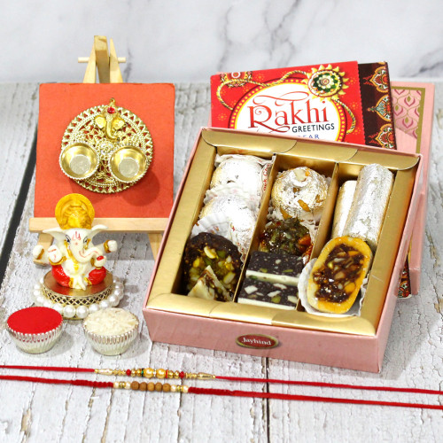 Wonderful Thali Combo - Kaju Mix, Ganesh Idol, Delicate Golden Ganesha Thali with Red Tika, 2 Rakhi, Free Greeting Card & Roli-Chawal