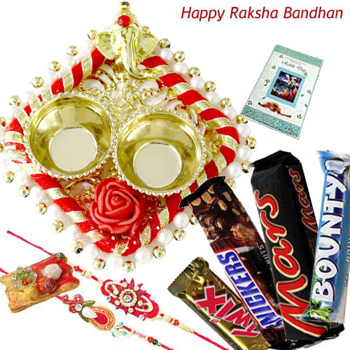 Chocolate Trip Thali - Auspicious Ganesha Thali with Pearls, Snickers, Mars, Twix, Bounty with 2 Fancy Rakhis, Free Greeting Card & Roli-Chawal