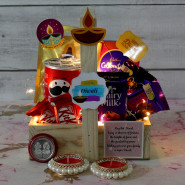 Diwali Blessings - Hershey's Kisses Milk Chocolates, Pringles, Mini Celebration, Dairy Milk Crackle, Dairy Milk Fruit n Nut, Dairy Milk, 2 Kit Kat, 5 Diwali Props, Led Light, Wooden Basket with 2 Decorative Golden Diyas and Laxmi-Ganesha Coin