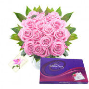 Missing You - 12 Pink Roses in Vase + Cadbury Celebration 128 gms + Card