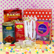 Mouthwatering Combo - Kaju Katli, Haldiram Soan Papdi, Haldiram Gulab Jamun, Mini Celebrations, Premium Gift Box (P) with 2 Rakhi and Roli-Chawal