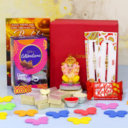 Tasty Mix - Kaju Katli, Mini Celebrations, 2 Kit Kat, Ganesh Idol, Premium Gift Box (M) with 2 Rakhi and Roli-Chawal