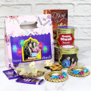 Diwali Surprise Hamper - Kaju Katli, Almonds in Personalized Tin, Cashews in Personalized Tin, 2 Dairy Milk, Pink Flower Personalized Gift Box with 2 Decorative Diyas and Laxmi-Ganesha Coin