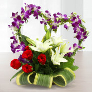 Pure Arrangement - 5 Purple Orchids, 5 Red Roses, 4 White Lilies in Heart Shape Arrangement in Basket and Card