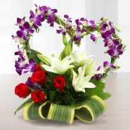 Pleasure of Love - 5 Purple Orchids, 5 Red Roses, 4 White Lilies in Heart Shape Arrangement in Basket & Valentine Greeting Card