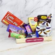 Perfect Presents - Sapphire Choco Chip Cookies, Dairy Milk Silk, Cadbury Chocobakes, Britania Cake, Nutri Choice Biscuits, Haldiram Namkeen, Oreo Biscuits, Lotte Choco Pie, 3 Personalized Props, Wooden Tray and Card 