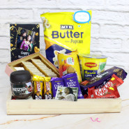 Basketful Sweets - Kaju Katli, Nescafe Classic Coffee, Act2 Popcorn, Hide & Seek Chocolate Biscuit, Nutri Choice Biscuits, Cup Noodles, 2 Dairy Milk, 2 Five Star, 2 Kit Kat, 2 Personalized Props, Wooden Tray and Pesonalized Card