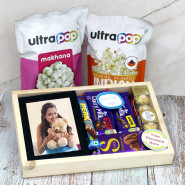 Basketful Joy - Ultra Pop Makhana, Ultra Pop Pop Corn, Photo Frame, Ferrero Rocher 4 Pcs, Dairy Milk Silk, Dairy Milk Fruit & Nut, Dairy Milk Crackle, Perk, 2 Personalized Props, Wooden Tray and Card