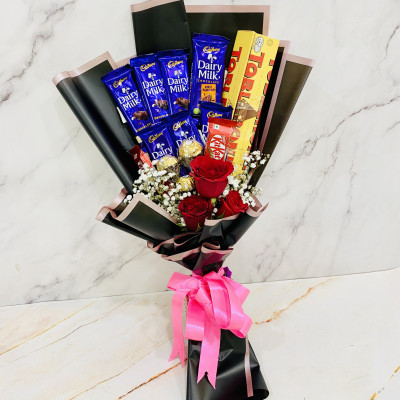 Tempting Choco Hamper - 3 Red Roses, 2 Dairy Milk Roast Almond, 2 Toblerone, 5 Cadbury Dairy Milk, 4 Kit Kat, Ferrero Rocher 3 pcs Bouquet